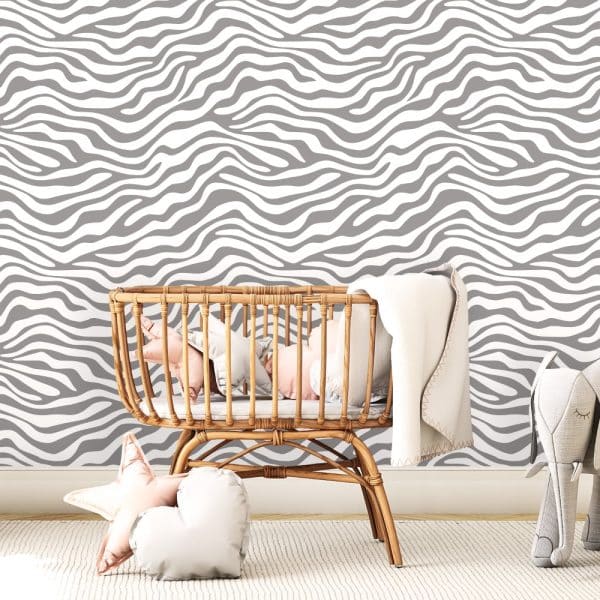 Baby In A Wicker Bassinet Against A Gray And White Zebra-Striped Wall.