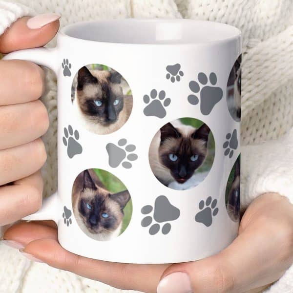 White Coffee Mug Featuring Multiple Images Of A Siamese Cat And Gray Paw Prints.