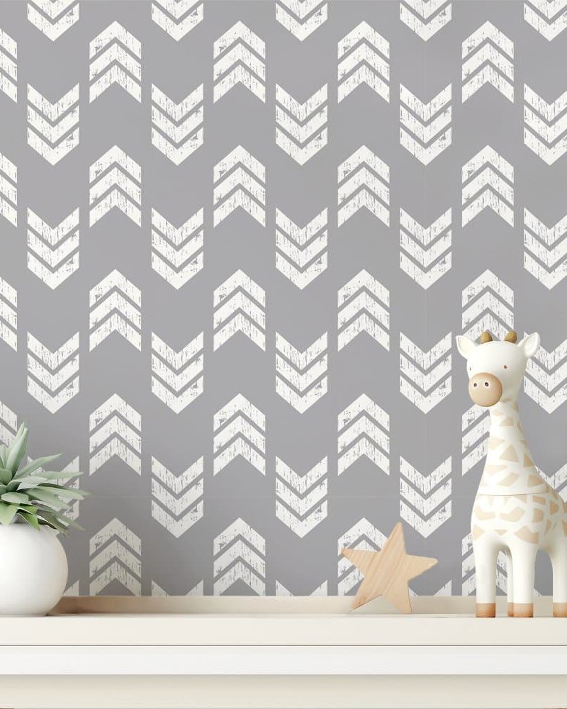 Gray chevron patterned wall with a small giraffe toy and a succulent plant on a shelf.
