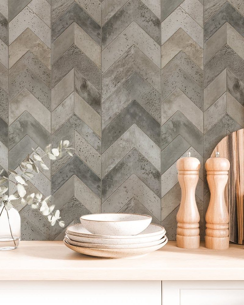 Chevron patterned grey and beige backsplash with kitchenware.