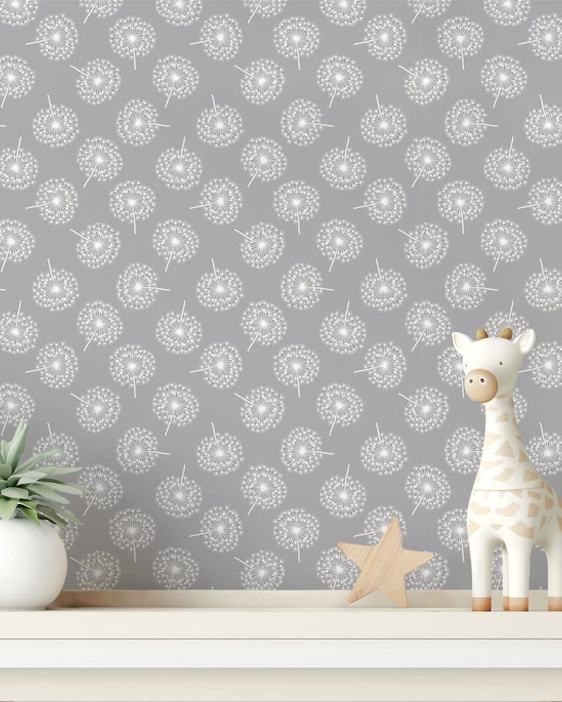 Grey wallpaper with a repeating pattern of white dandelions. A small wooden giraffe and star sit on a shelf in front of the wallpaper.