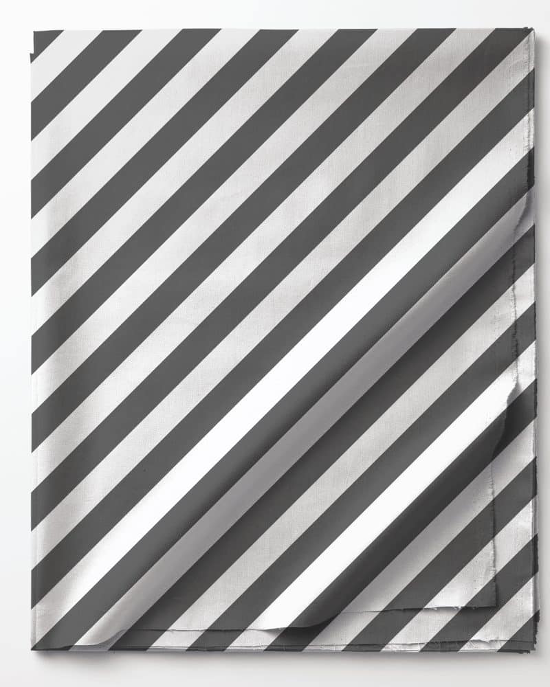 Grey and white diagonally striped fabric folded on a white background.