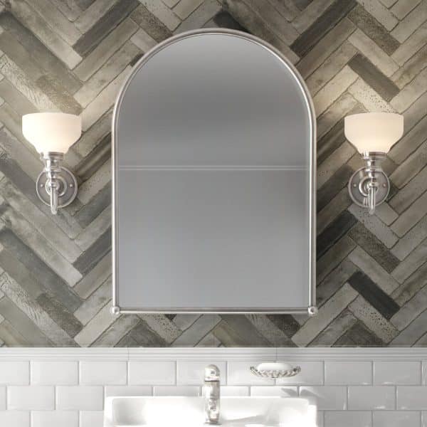 Arch-Shaped Medicine Cabinet With Flanking Wall Lights Above A Bathroom Sink.