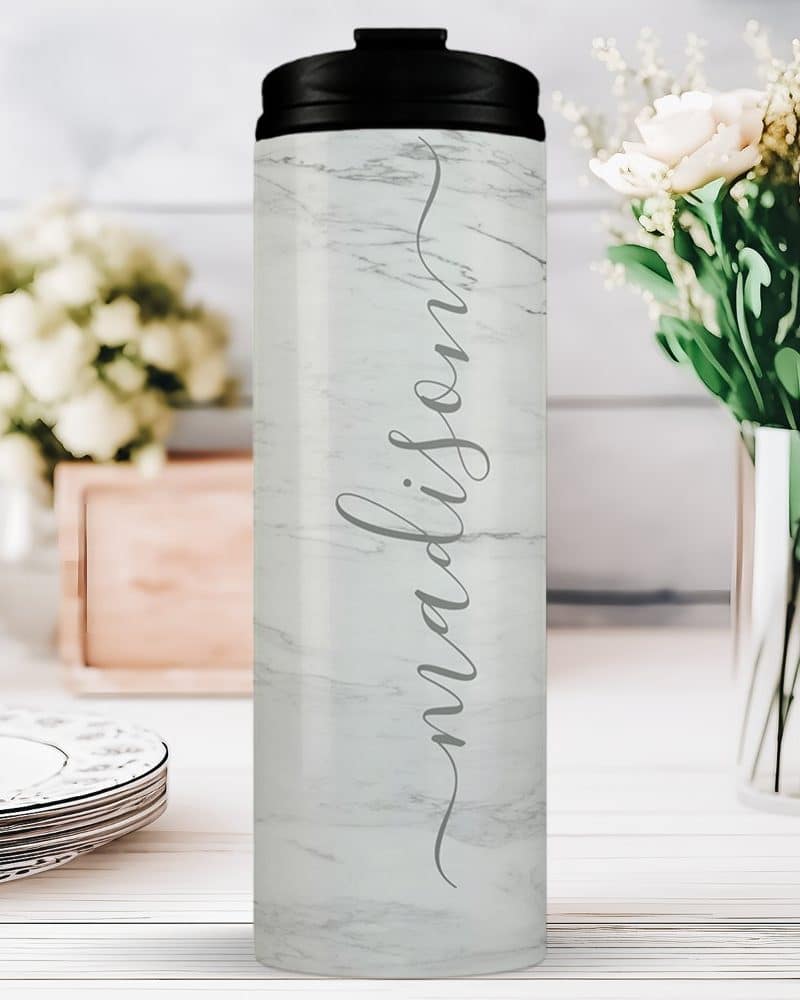 White marble tumbler with the name Madison in a script font.