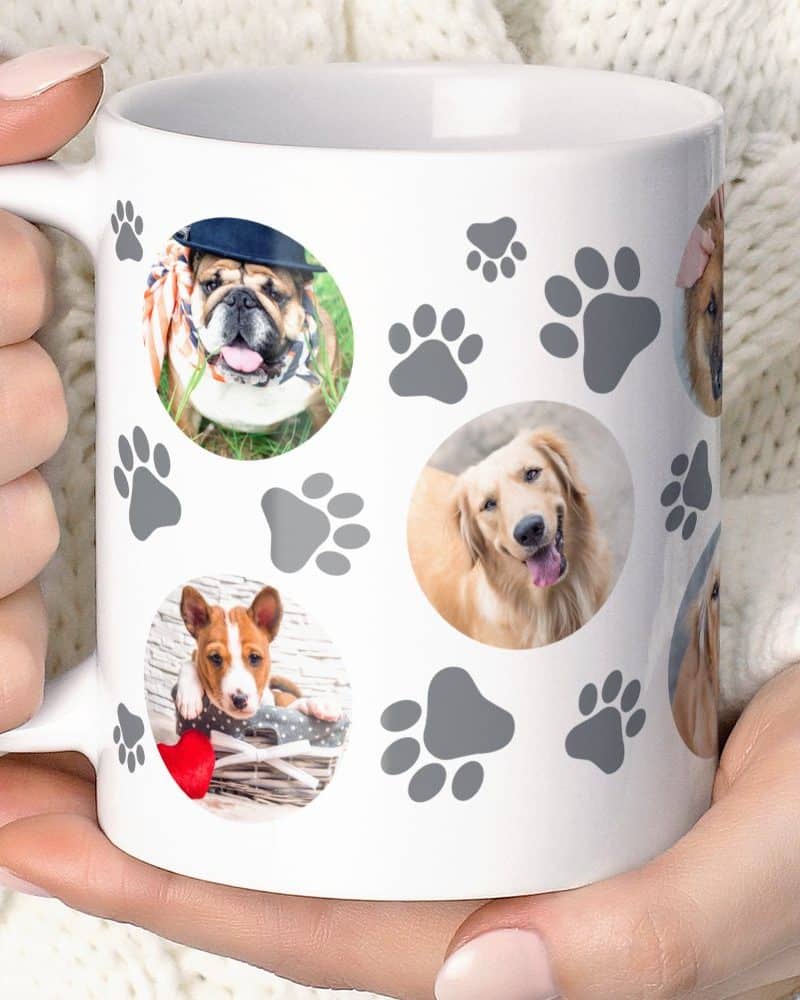 White coffee mug featuring multiple photos of dogs and grey paw prints.