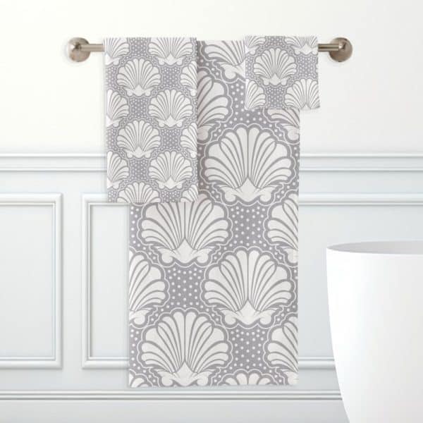 Gray And White Bath Towels With A Seashell Pattern.