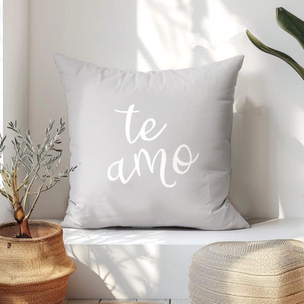 Light Gray Throw Pillow With The Words Te Amo In White Script.