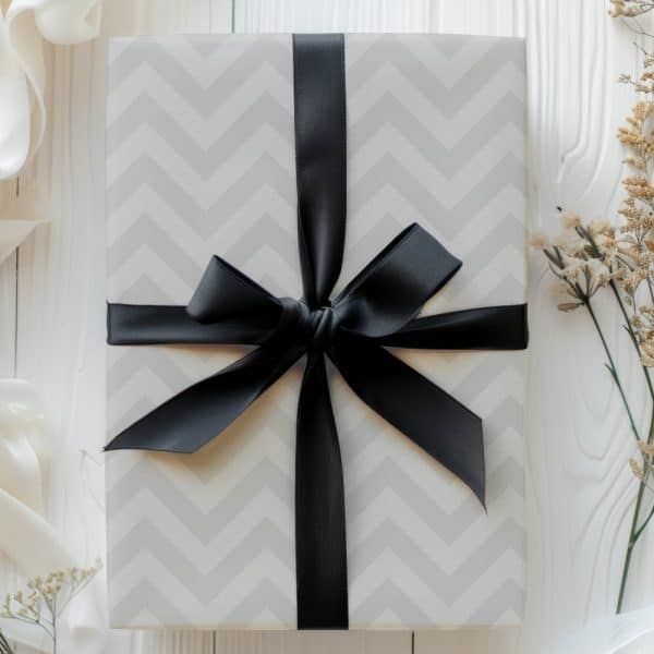 A Gift Box With A Chevron Pattern And A Black Ribbon.