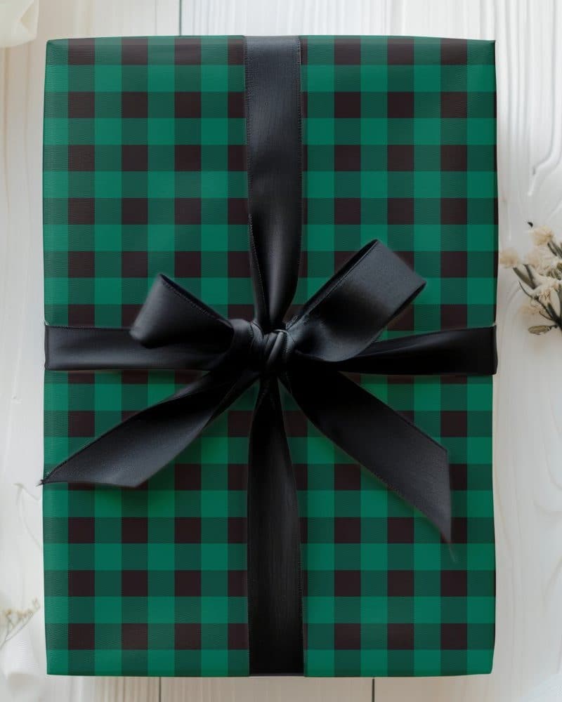 Green and black plaid gift box with a black ribbon.