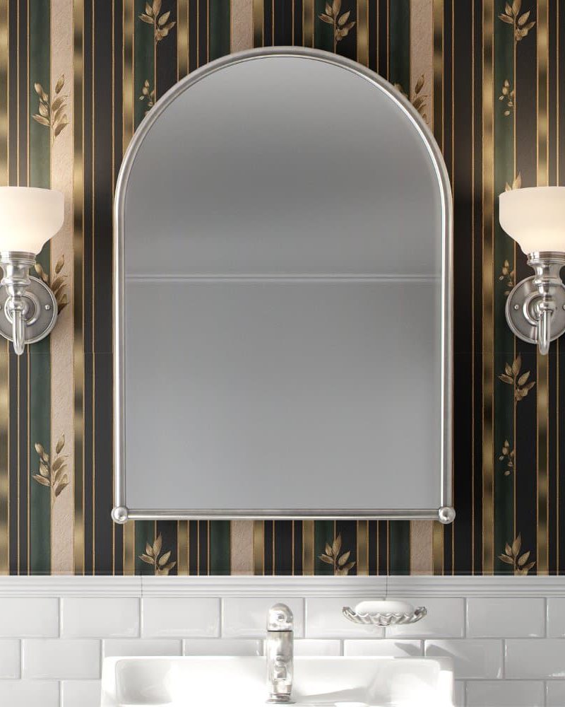 Arched mirror flanked by wall sconces above a bathroom sink.