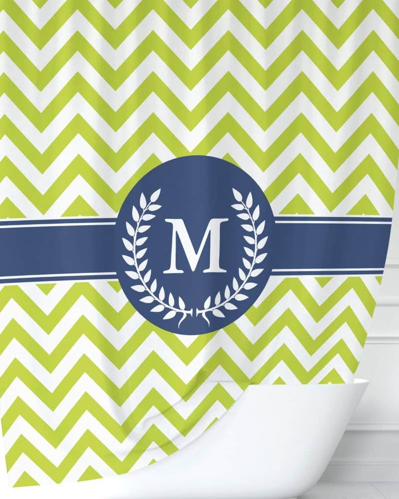 Lime green chevron shower curtain with a navy blue circle monogram featuring the letter M and laurel wreath.