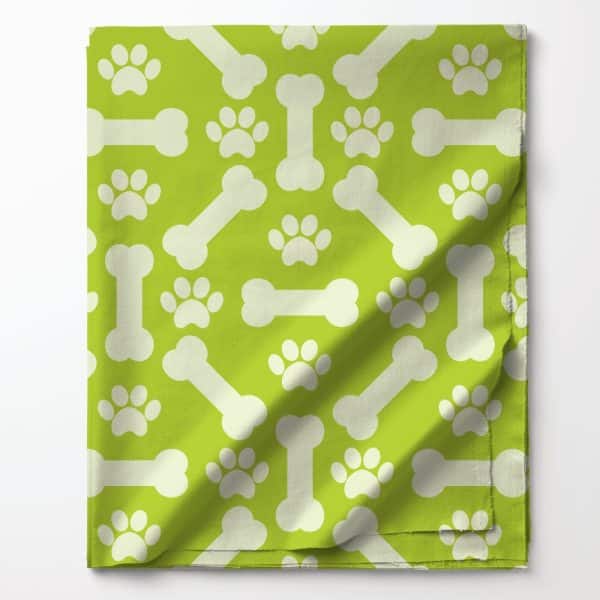 Lime Green Fabric With A Repeating Pattern Of White Bones And Paw Prints.