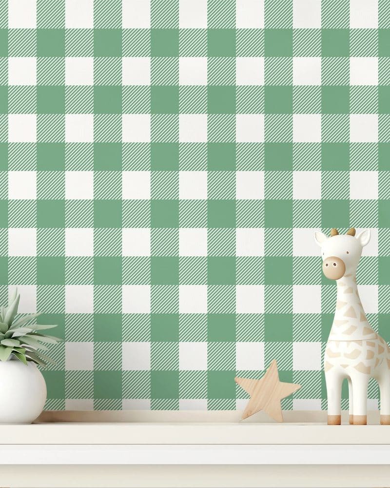 Sage green and white gingham wallpaper with a small giraffe toy and potted plant on a shelf.