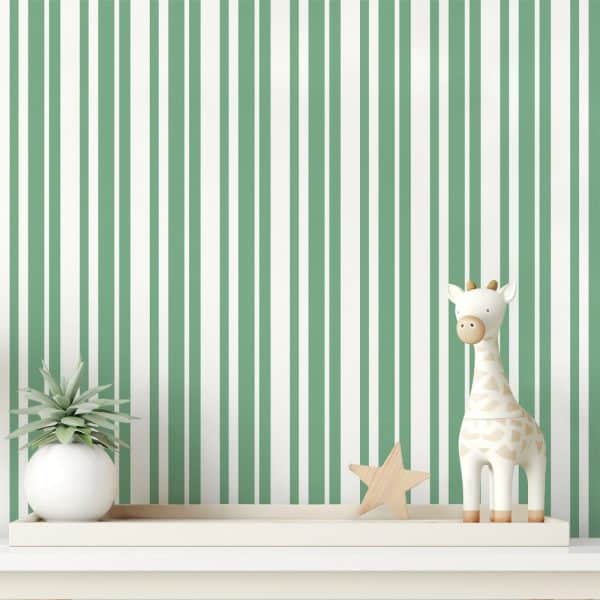 A White Giraffe Toy And A Wooden Star Sit On A Shelf Against A Wall With Vertical Green And White Stripes.