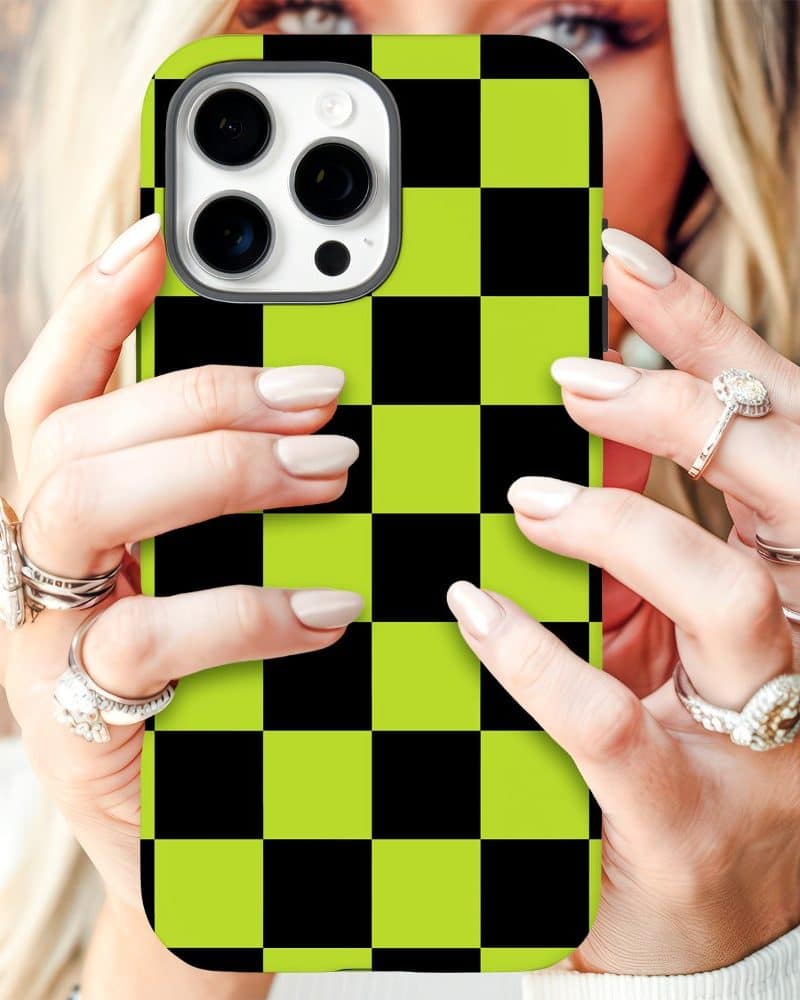 Close-up of hands holding a lime green and black checkered iPhone case.