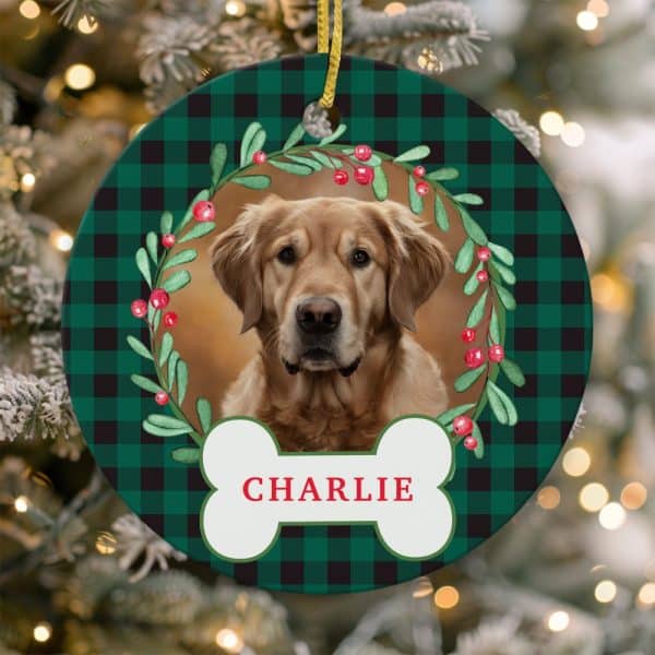 Round Christmas Ornament Featuring A Golden Retriever Within A Green And Black Plaid Design And A Holly Wreath. The Dog'S Name, Charlie, Is On A Bone-Shaped Tag.