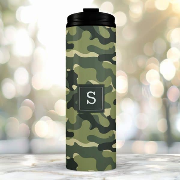 Camouflage Travel Tumbler With A Black Lid And The Letter S In A Gray Square.