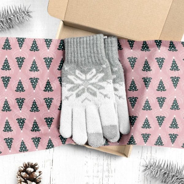 Gray And White Knit Gloves With Snowflake Pattern, In A Box Lined With Christmas Tree Wrapping Paper.