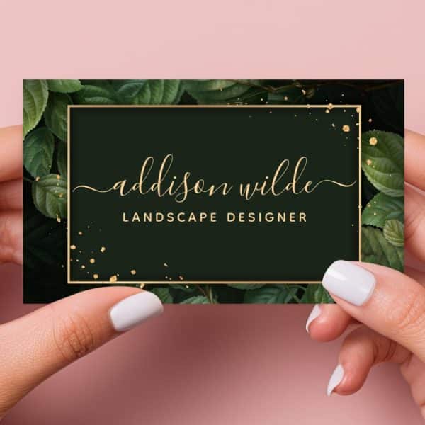 Business Card For Addison Wilde, Landscape Designer. The Card Features A Dark Green Background With Gold Lettering And Leaf Illustrations.