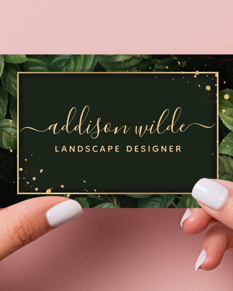 Business card for Addison Wilde, Landscape Designer. The card features a dark green background with gold lettering and leaf illustrations.