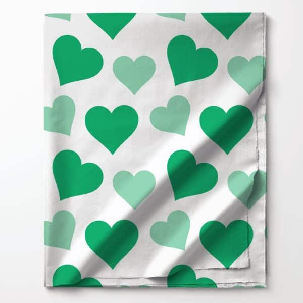 Green And Light Green Hearts On White Fabric.