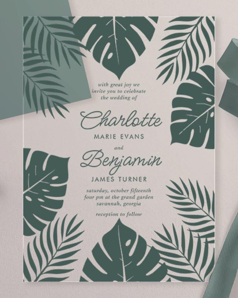 Wedding invitation for Charlotte Evans and Benjamin Turner, featuring a tropical leaf design.