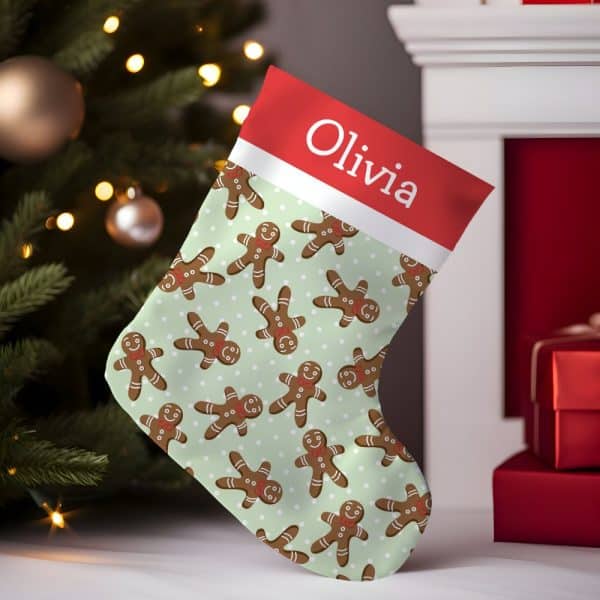 Personalized Christmas Stocking With A Light Green Background And A Repeating Pattern Of Gingerbread Men. The Stocking Is Labeled Olivia.