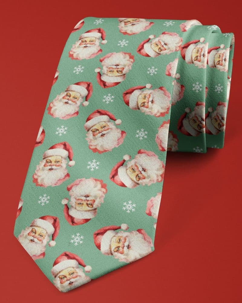 Teal necktie with a repeating pattern of Santa Claus faces and snowflakes.