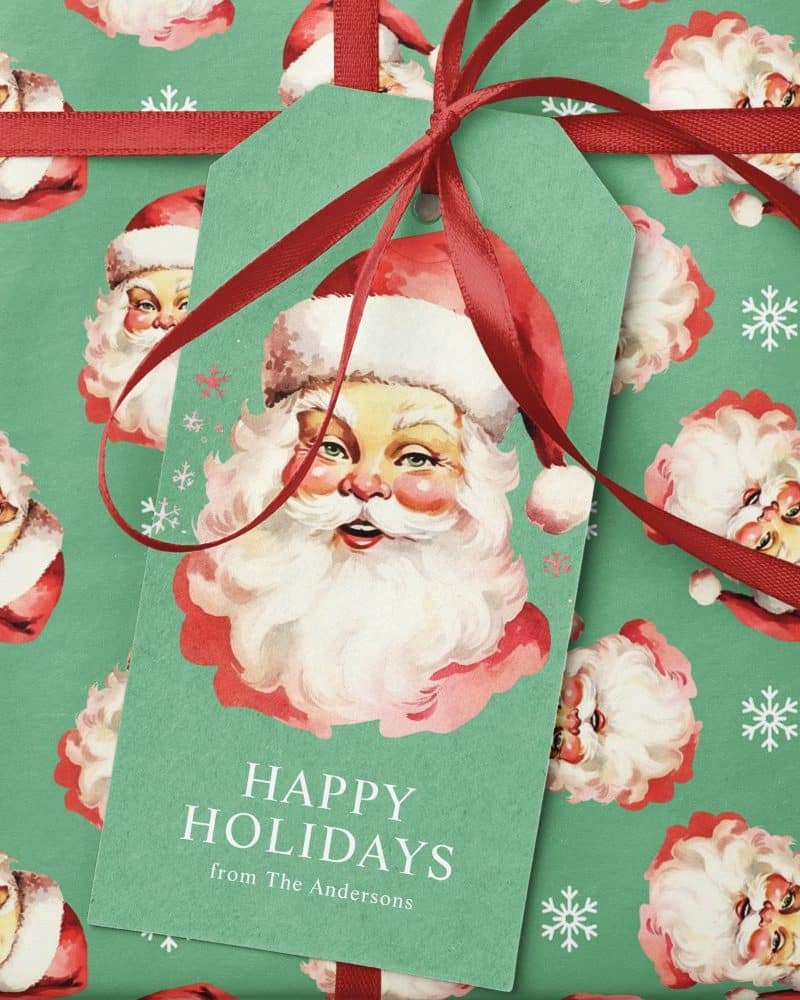 Gift tag on wrapping paper with a vintage Santa illustration and Happy Holidays message.