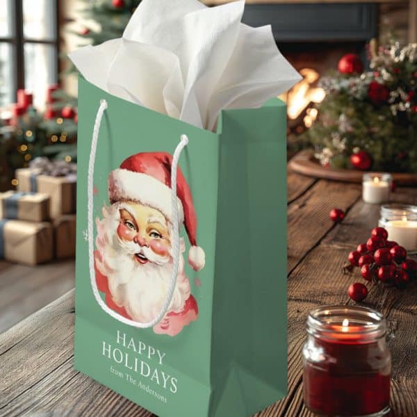 Green Gift Bag With A Vintage Santa Claus Illustration, Text Reading Happy Holidays From The Andersons.