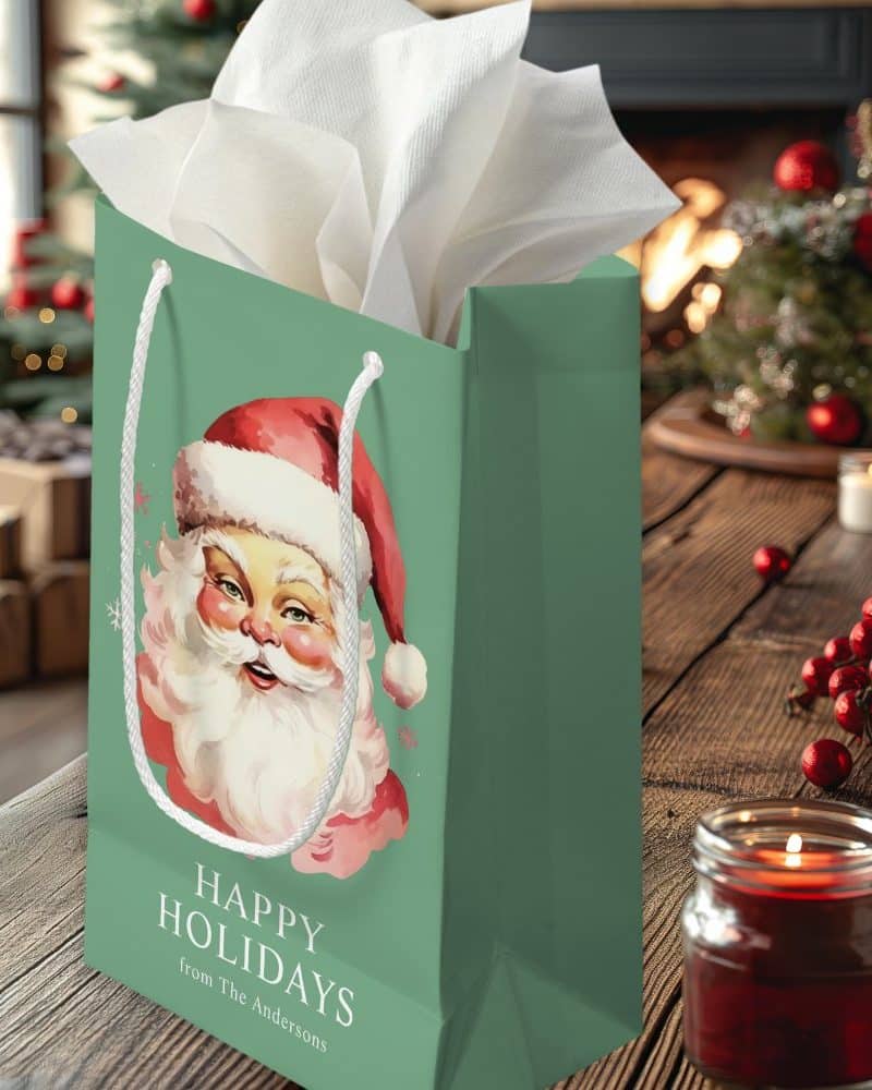 Green gift bag with a vintage Santa Claus illustration, text reading Happy Holidays from The Andersons.