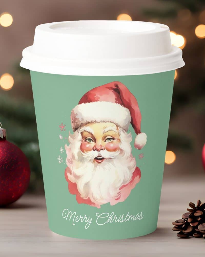 A teal Christmas coffee cup featuring a vintage illustration of Santa Claus. Merry Christmas is written below.