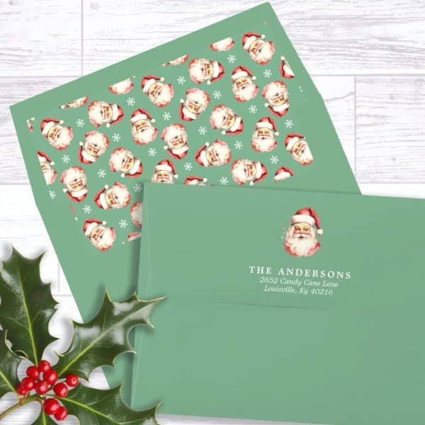 A Green Christmas Envelope With A Santa Claus Pattern And A Return Address Label.