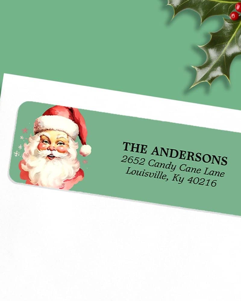 A teal Christmas return address label with a vintage illustration of Santa Claus and the address The Andersons, 2652 Candy Cane Lane, Louisville, Ky 40216.