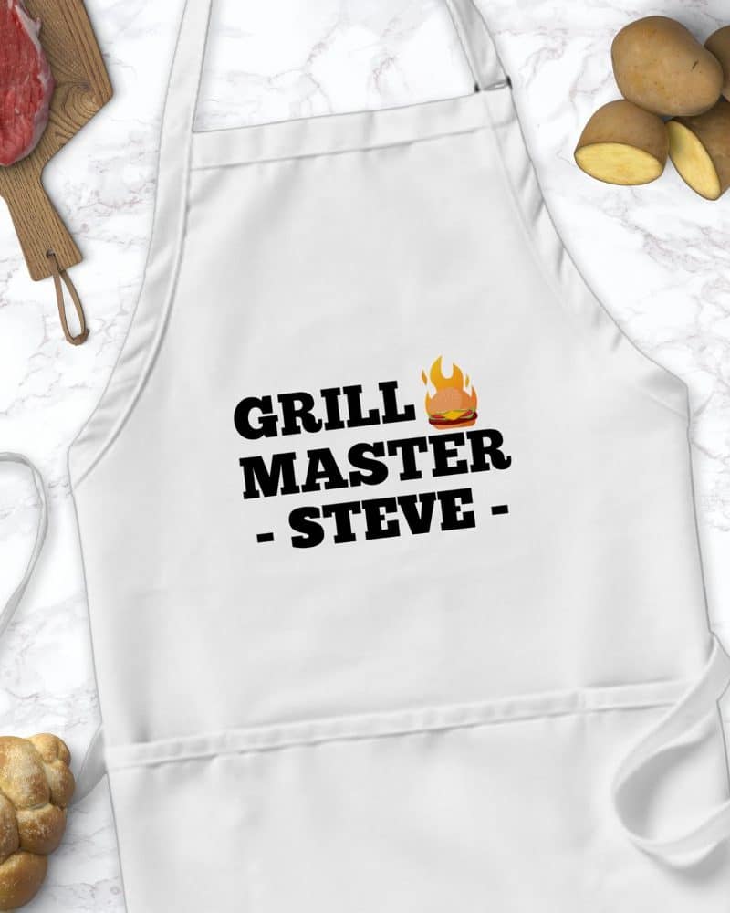White apron with Grill Master Steve text and a small burger and flame graphic.