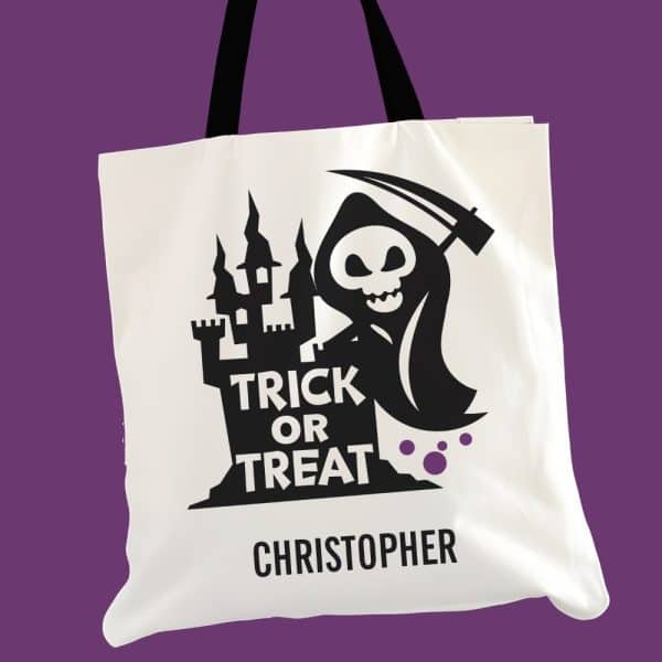 White Trick Or Treat Tote Bag With A Black Grim Reaper And Castle Design. The Bag Is Personalized With The Name Christopher.