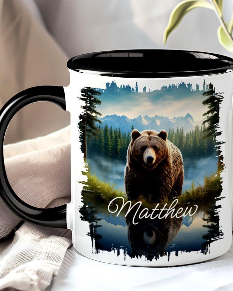 Personalized coffee mug with a grizzly bear in a mountain lake scene, the name Matthew printed below.