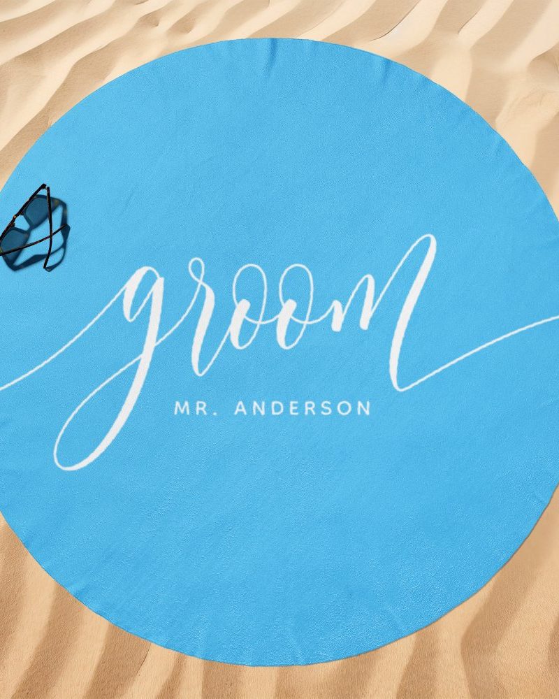 Light blue round beach towel with the word groom and Mr. Anderson in white script.