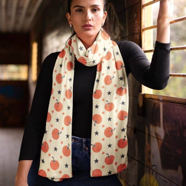 Woman Wearing A Cream-Colored Scarf With Orange Pumpkins And Black Stars.