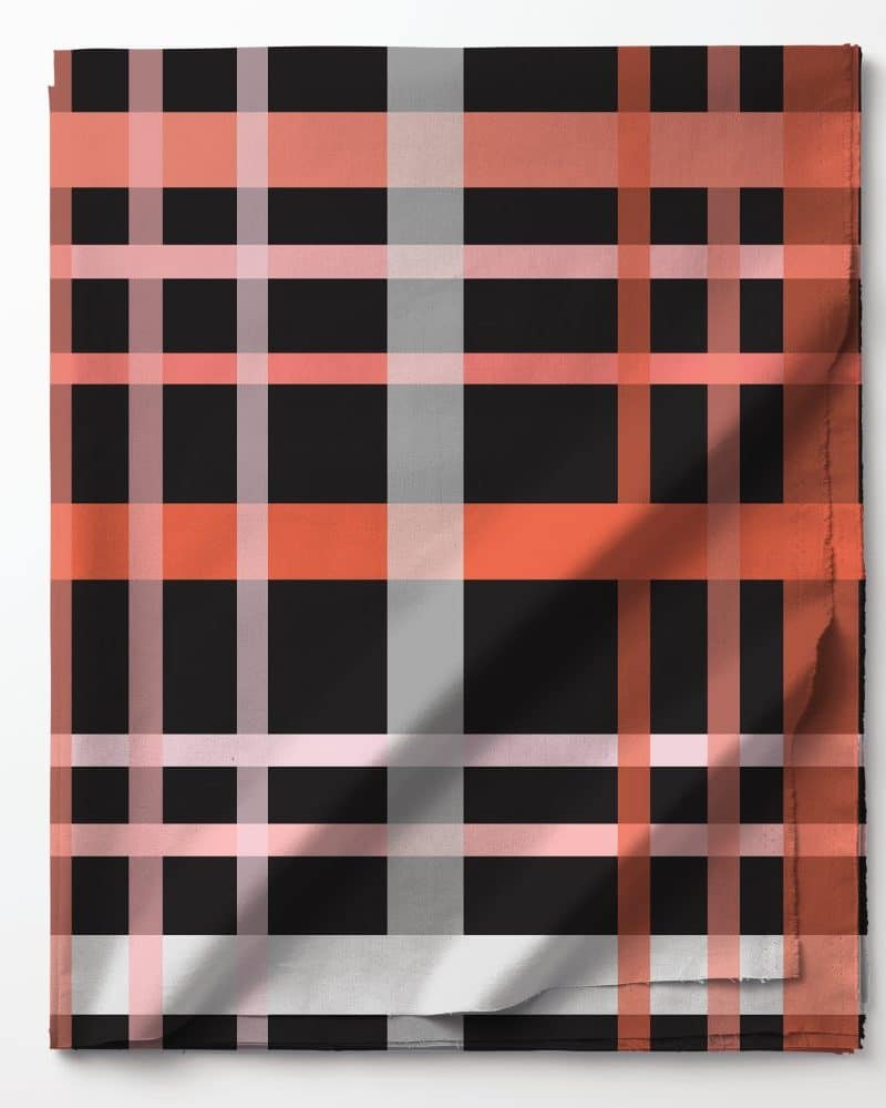 Folded fabric with a black, coral, and gray plaid pattern.