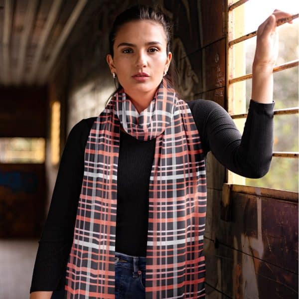 Woman Wearing A Coral And Black Plaid Scarf.