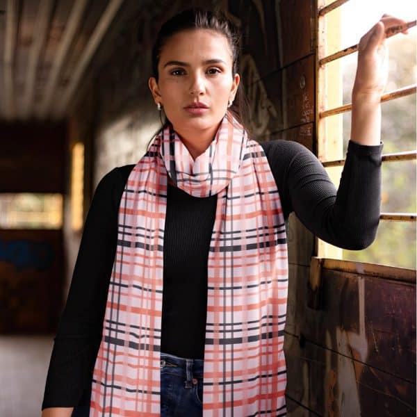 Woman Wearing A Peach And Gray Plaid Scarf.