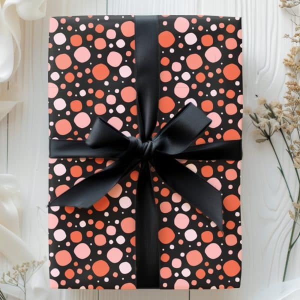 Gift Wrapped In Black And Coral Polka Dot Paper With A Black Ribbon.