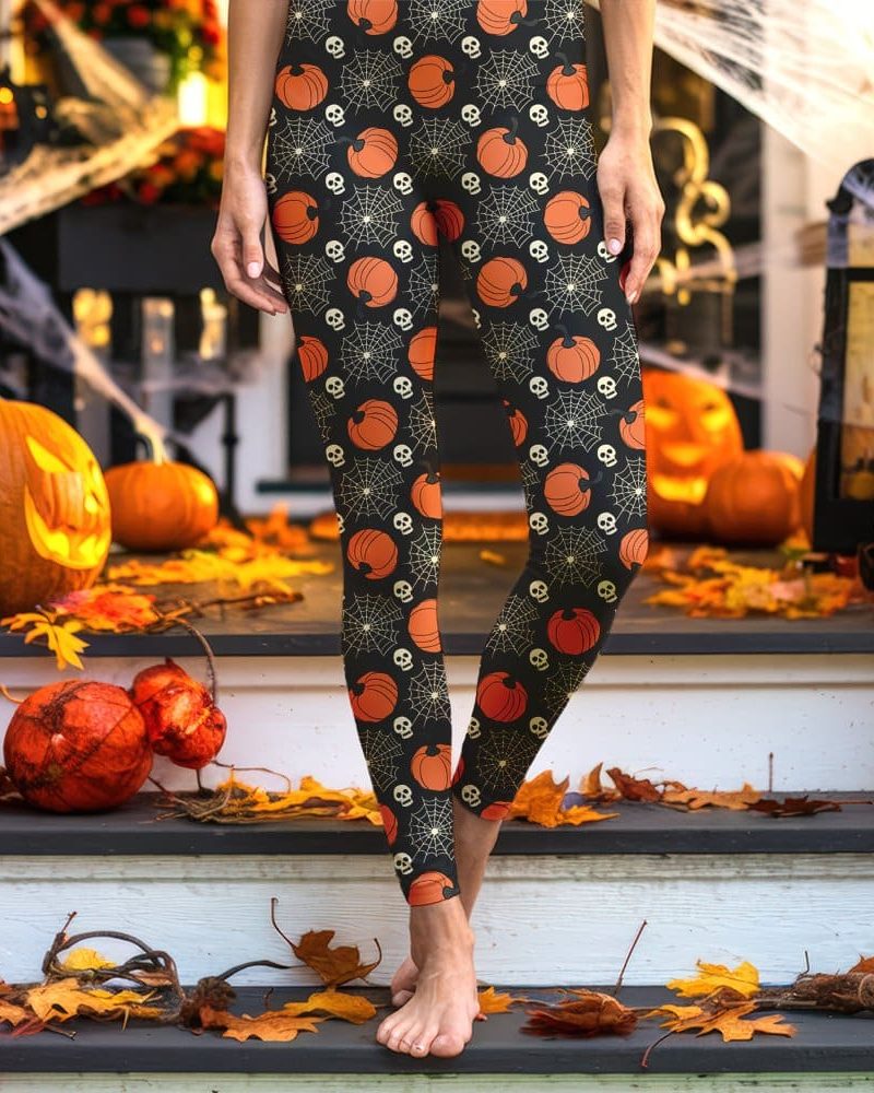 Legs wearing black leggings with a Halloween pattern of pumpkins and skulls.