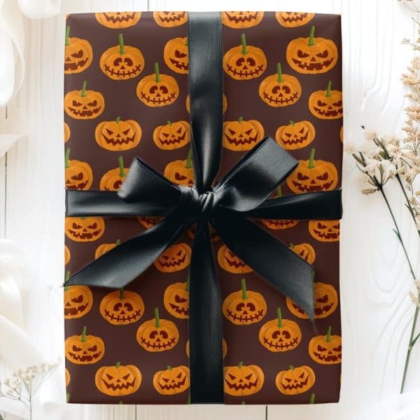 Gift Wrapped In Brown Paper With A Halloween Jack-O-Lantern Pattern And A Black Ribbon.