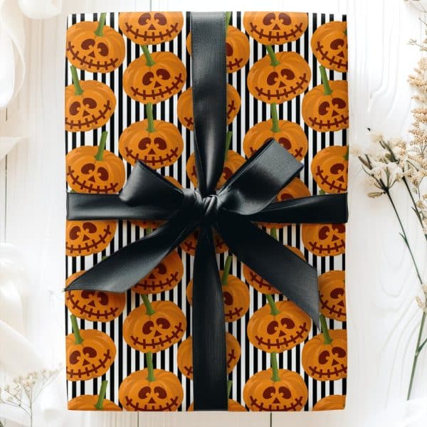 Halloween Gift Wrapped In Black And White Striped Paper With A Pattern Of Jack-O'-Lantern Faces And Tied With A Black Ribbon.