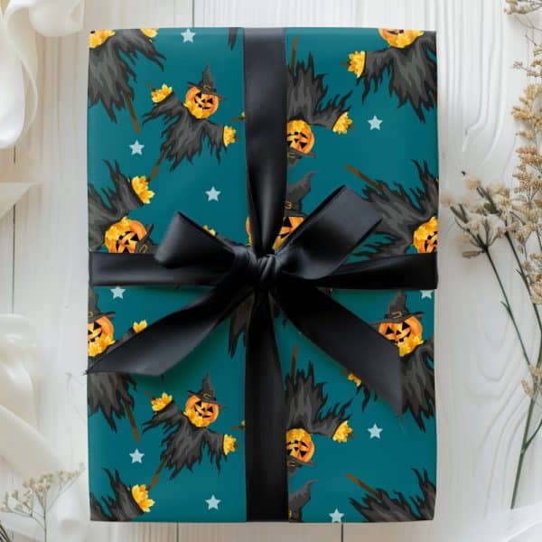 Teal Halloween Gift Wrapped With A Black Ribbon, Featuring A Pattern Of Scarecrows With Jack-O'-Lantern Heads.