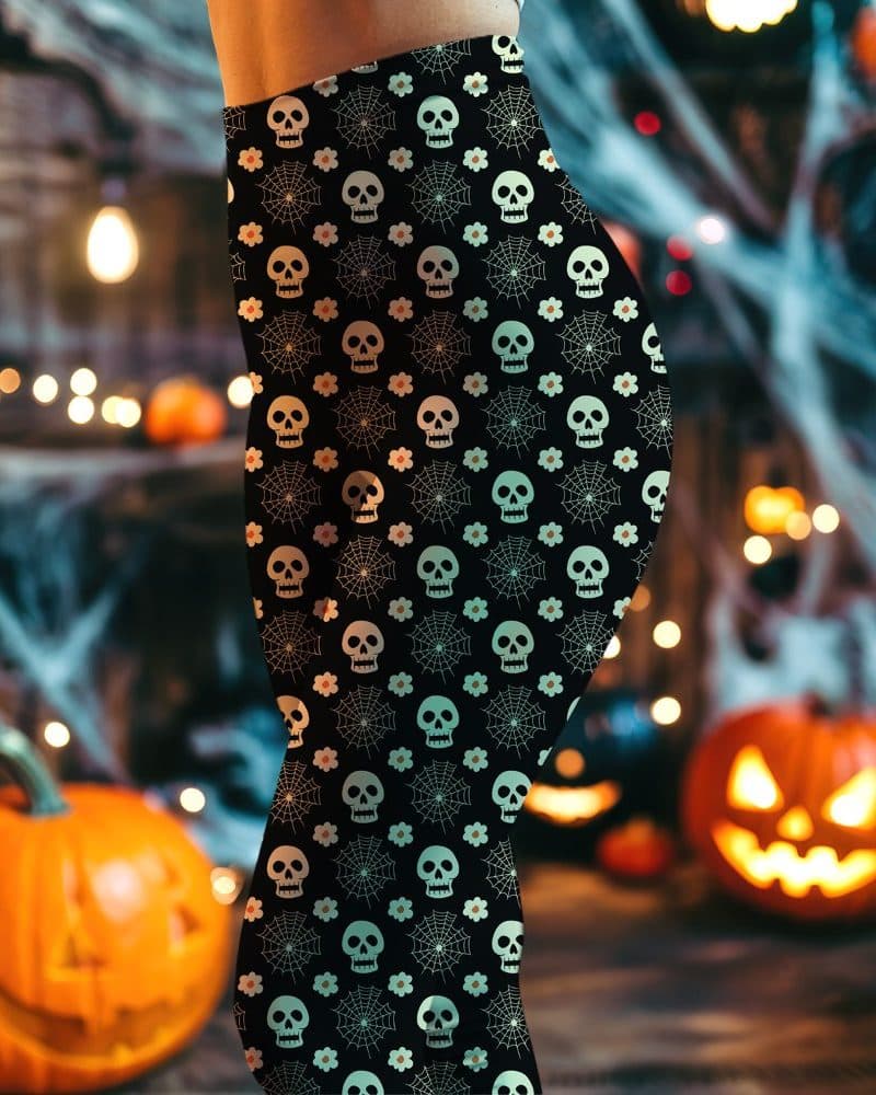 Black leggings with a Halloween pattern of skulls, spiderwebs, and flowers.