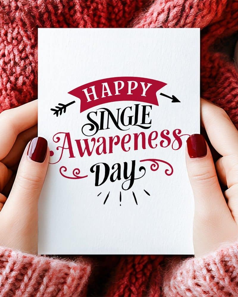 Hands hold a card that says Happy Single Awareness Day.