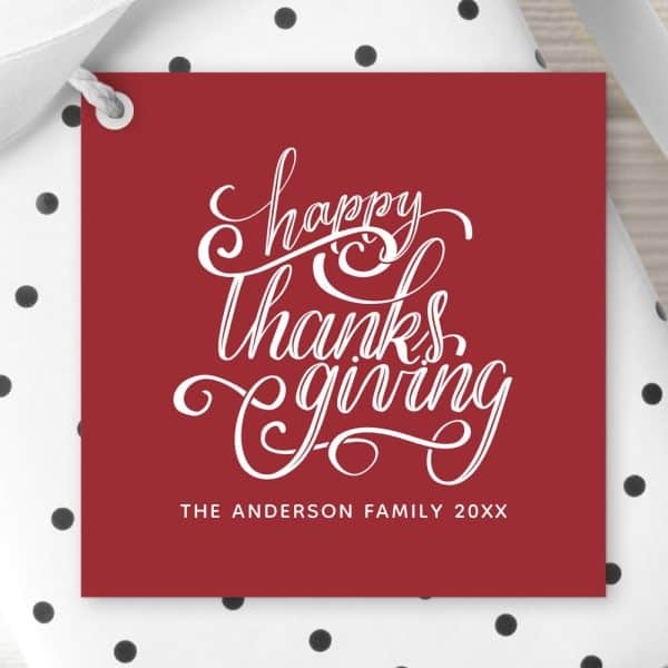 Red Thanksgiving Gift Tag With White Script Lettering That Says Happy Thanksgiving. The Anderson Family 20Xx Is Also Printed On The Tag.